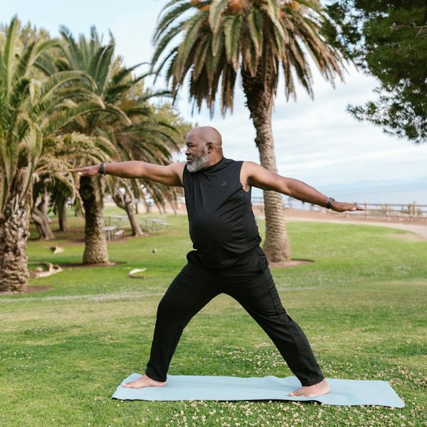 Person meditating peacefully outdoors in a natural setting.